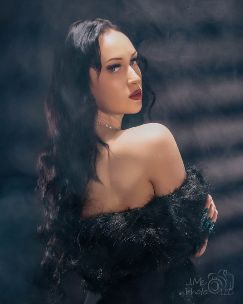 Autumn in a black dress in soft haze, looking away from the camera